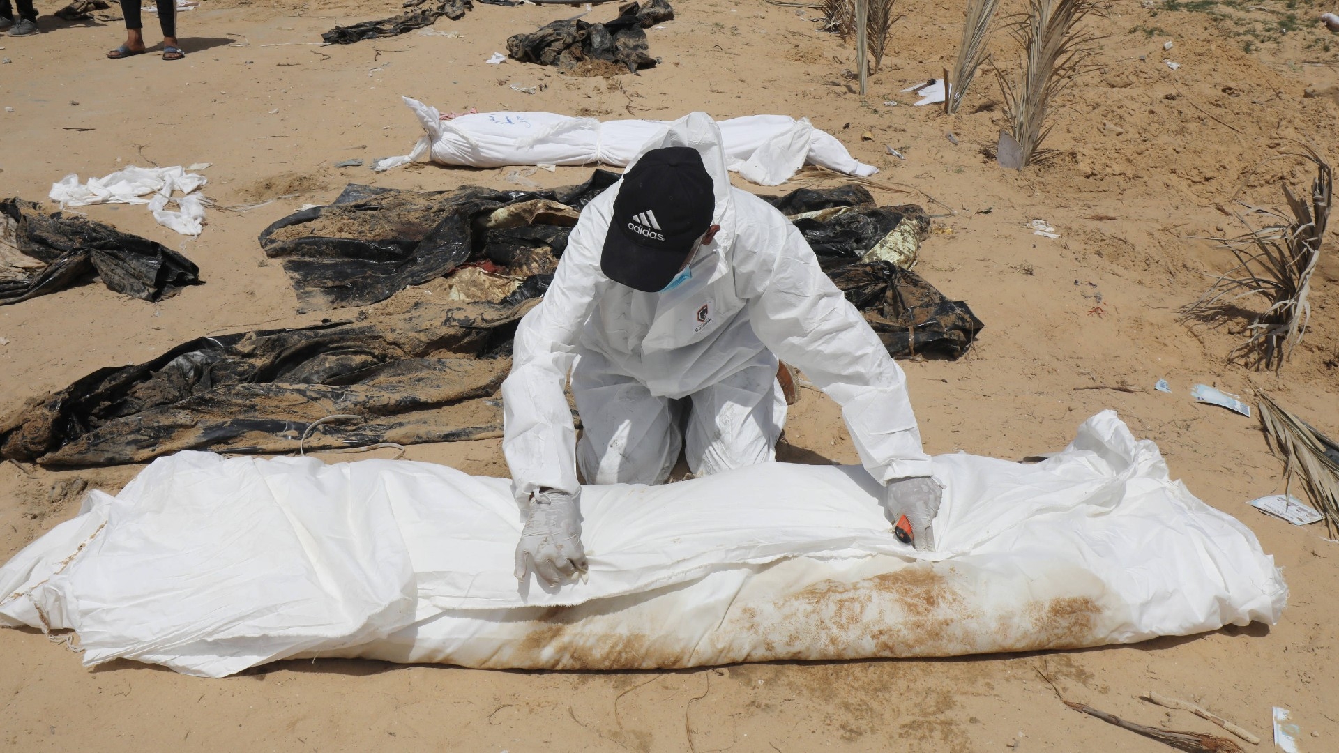 Palestinian health workers unearth bodies buried by Israeli forces in Nasser hospital on 21 April (Reuters/Omar Ashtawy/apaimages)